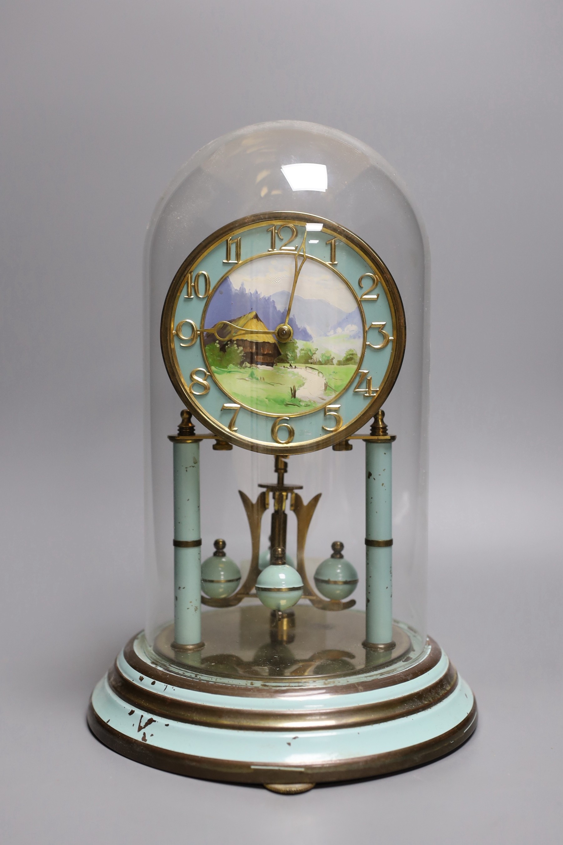 A German 400 day enamelled brass mantel timepiece, under a glass dome, 30cm total